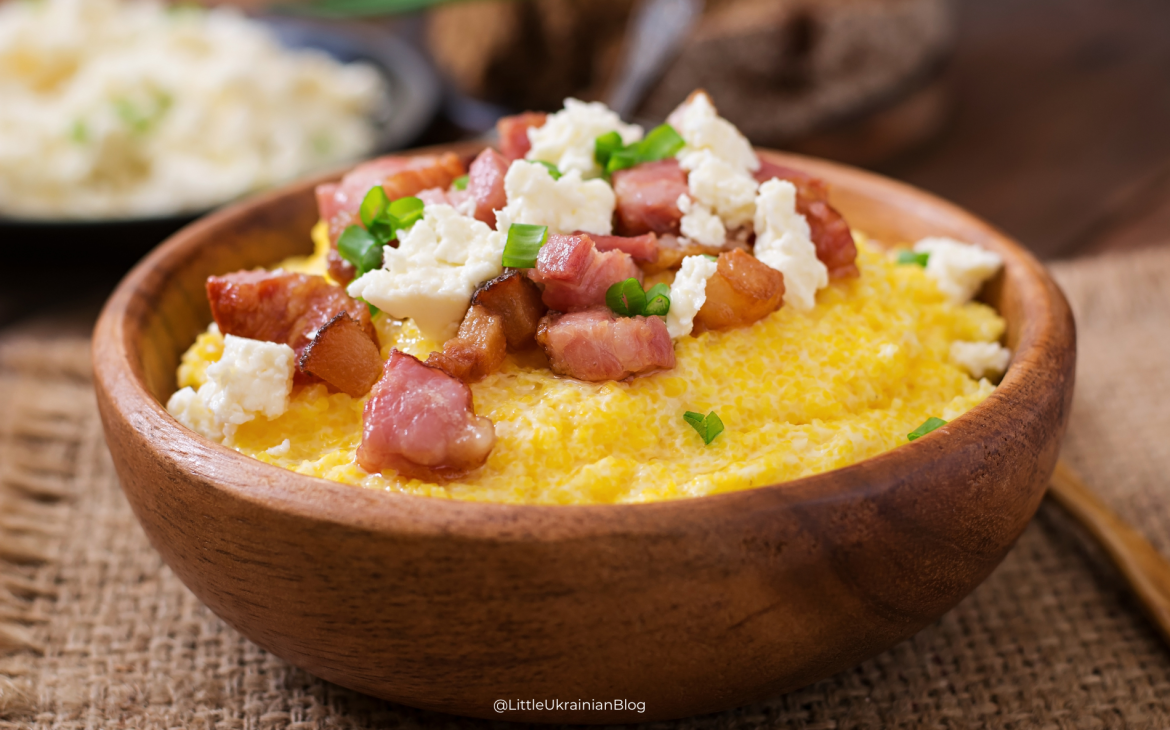 Traditional Ukrainian banosh from the Carpathian Mountains topped with bryndza cheese and crispy salo, a classic Hutsul dish from western Ukraine.
