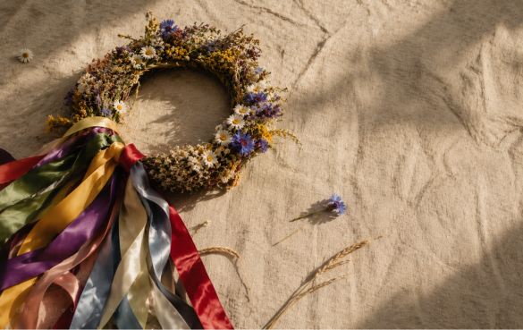 Traditional Ukrainian vinok (flower crown) with colourful ribbons, chamomile, cornflowers, viburnum and wheat, photographed on linen fabric. The vinok is an iconic symbol of Ukrainian culture, folklore, heritage, flower symbolism and traditional customs.